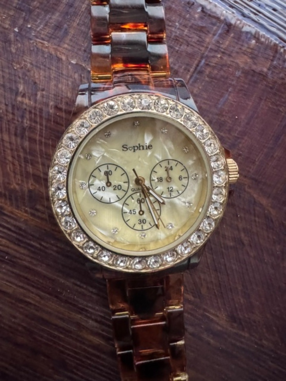 Sophie brand analog/gold-tone bezel set with rhinestones/tortoiseshell-pattern